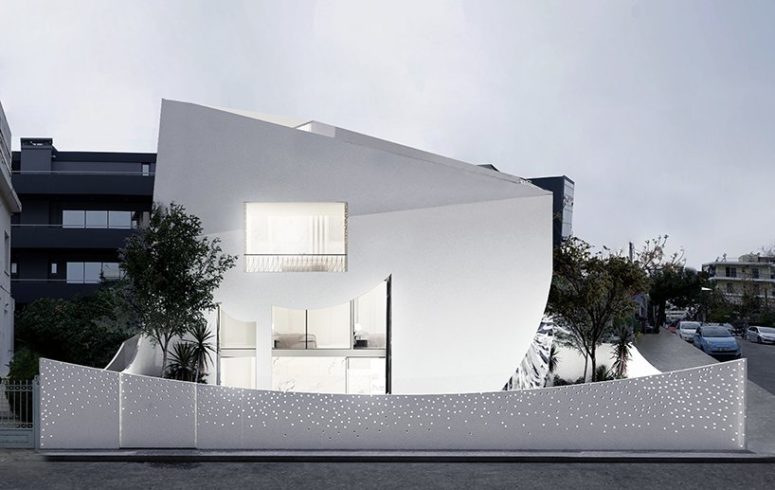 This unique minimalist house in white is filled with light and has a perforated facade, its interior and exterior are both unusual This unique minimalist house in white is filled with light and has a perforated facade, its interior and exterior are both unusual