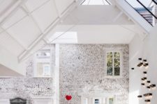 02 The architects took best of sloped ceilings making skylights, highlighted the brick walls and added art everywhere