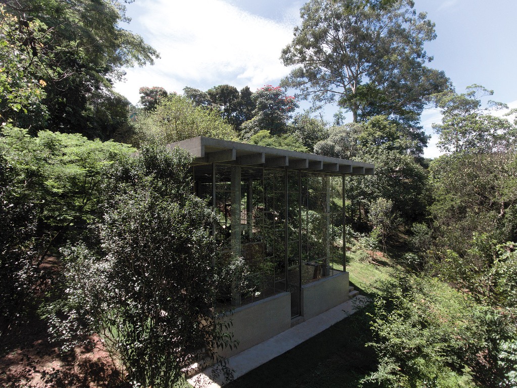 The house is built into a slope and looks totally harmonious there, glass walls allow enjoying the views