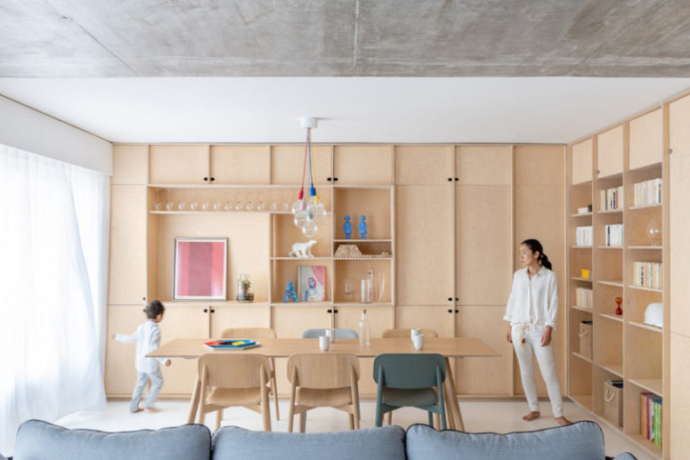 The living room is united with a dining space, there are lots of light colroed plywood cabinets for storage The living room is united with a dining space, there are lots of light-colroed plywood cabinets for storage