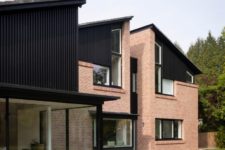 02 There are large windows and glazed walls to brign more light inside, and the exterior looks very stylish with red brick and black wood