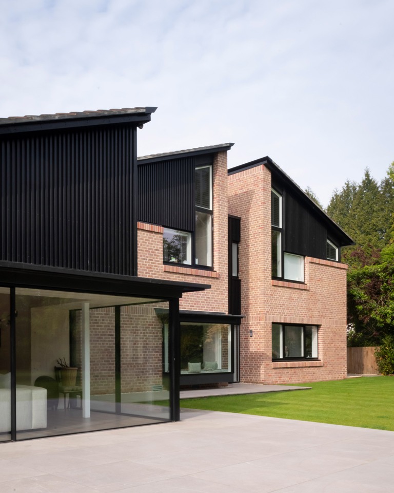 There are large windows and glazed walls to brign more light inside, and the exterior looks very stylish with red brick and black wood There are large windows and glazed walls to brign more light inside, and the exterior looks very stylish with red brick and black wood