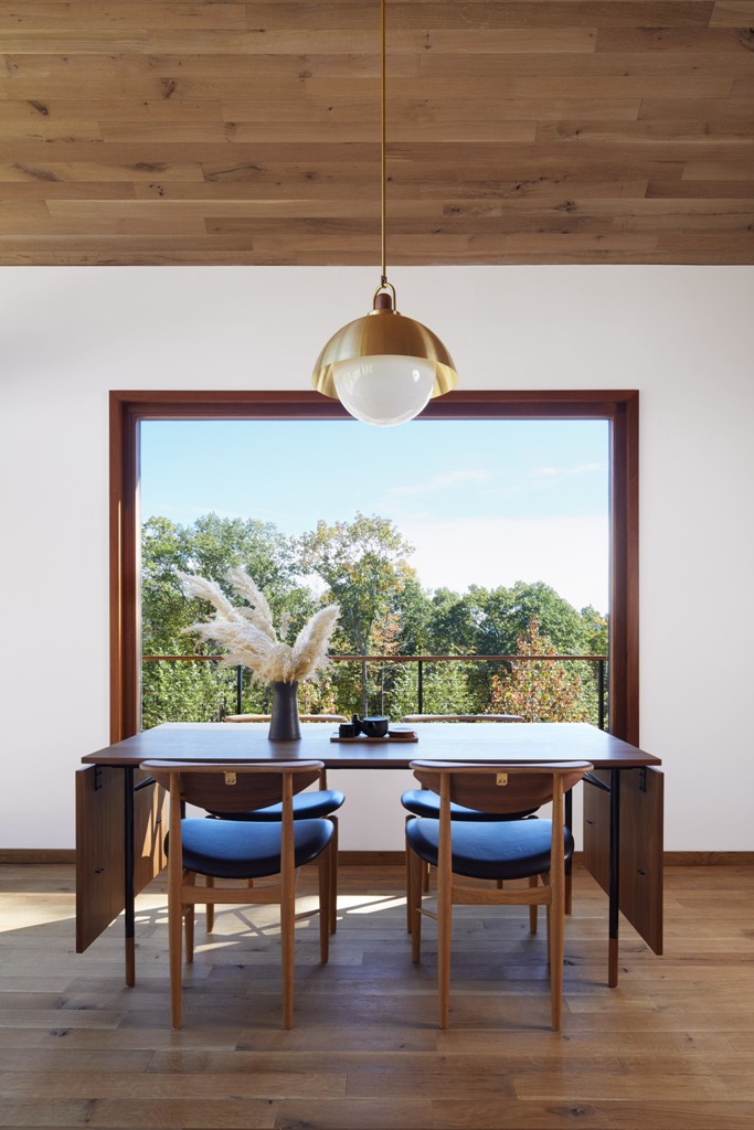 The dining space is done with a folding table and stylish leather chairs and is located next to the window to maximize the light and views The dining space is done with a folding table and stylish leather chairs and is located next to the window to maximize the light and views
