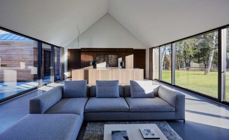 The glass walls bring much light inside and the interiors are minimalist with laconic furniture and sleek surfaces The glass walls bring much light inside and the interiors are minimalist - with laconic furniture and sleek surfaces