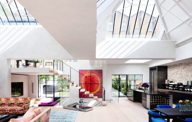 The main layout is an open space with a living room, a lounge, a dining room and a kitchen and there are lots of colorful touches