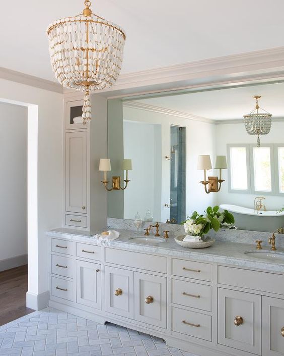 a beautiful brass and mother-of-pearl chandelier for making a statement in a traditional bathroom