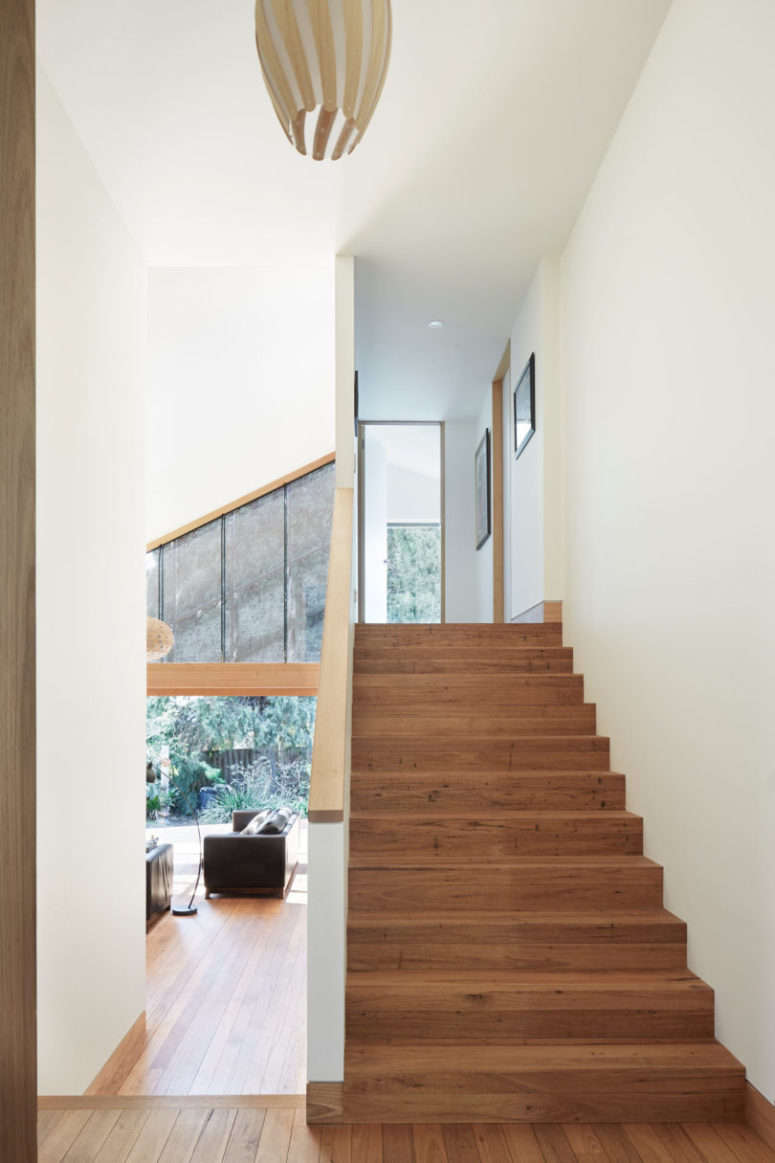 A simple wooden staircase leads upstairs to sleeping zones