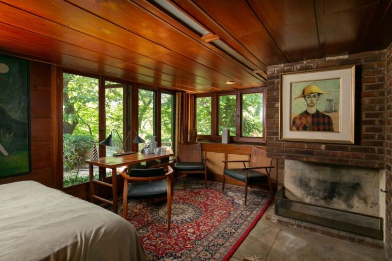 The bedroom features a fireplace and a cool home office zone with a wooden desk and some leather chairs The bedroom features a fireplace and a cool home office zone with a wooden desk and some leather chairs