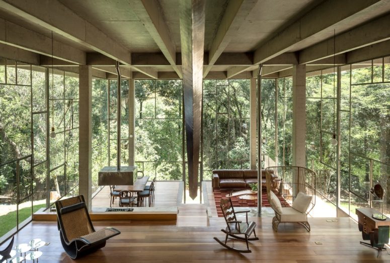 The house is done with several different spaces that are divided with glass partitions or not divided at all The house is done with several different spaces that are divided with glass partitions or not divided at all