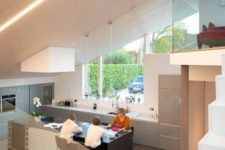 04 The kitchen is glazed, with built-in lights and sleek cabinets, the surfaces are rather sleek and chic