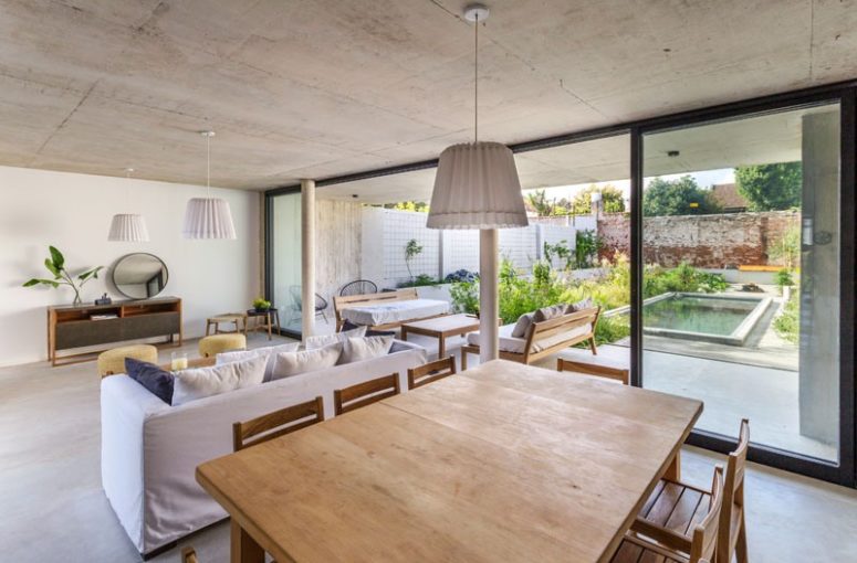 The main space is open plan, with a kitchen, dining room and living room, and it's extended outdoors to a terrace with a pool The main space is open plan, with a kitchen, dining room and living room, and it's extended outdoors - to a terrace with a pool