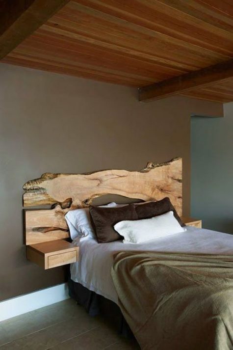 a live edge wooden headboard with little floating nightstands adds a natural feel to the space