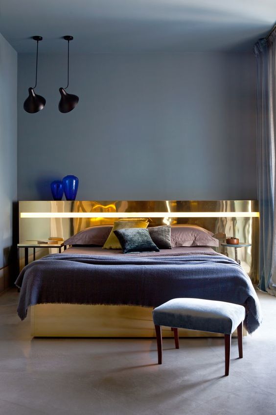a unique and statement-like polished gold headboard is a refined and glam touch to the bedroom decor