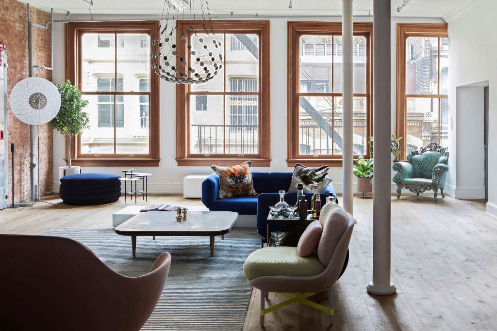 The main space is an open layout filled with light, greenery and eye catchy furniture pieces
