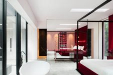 06 The master bedroom and bathroom is done with deep red touches and an oval tub is placed right next to the bed