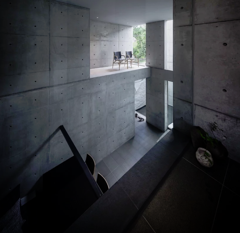 Much concrete and matte black tiles are softened with much natural light and potted greenery here and there Much concrete and matte black tiles are softened with much natural light and potted greenery here and there