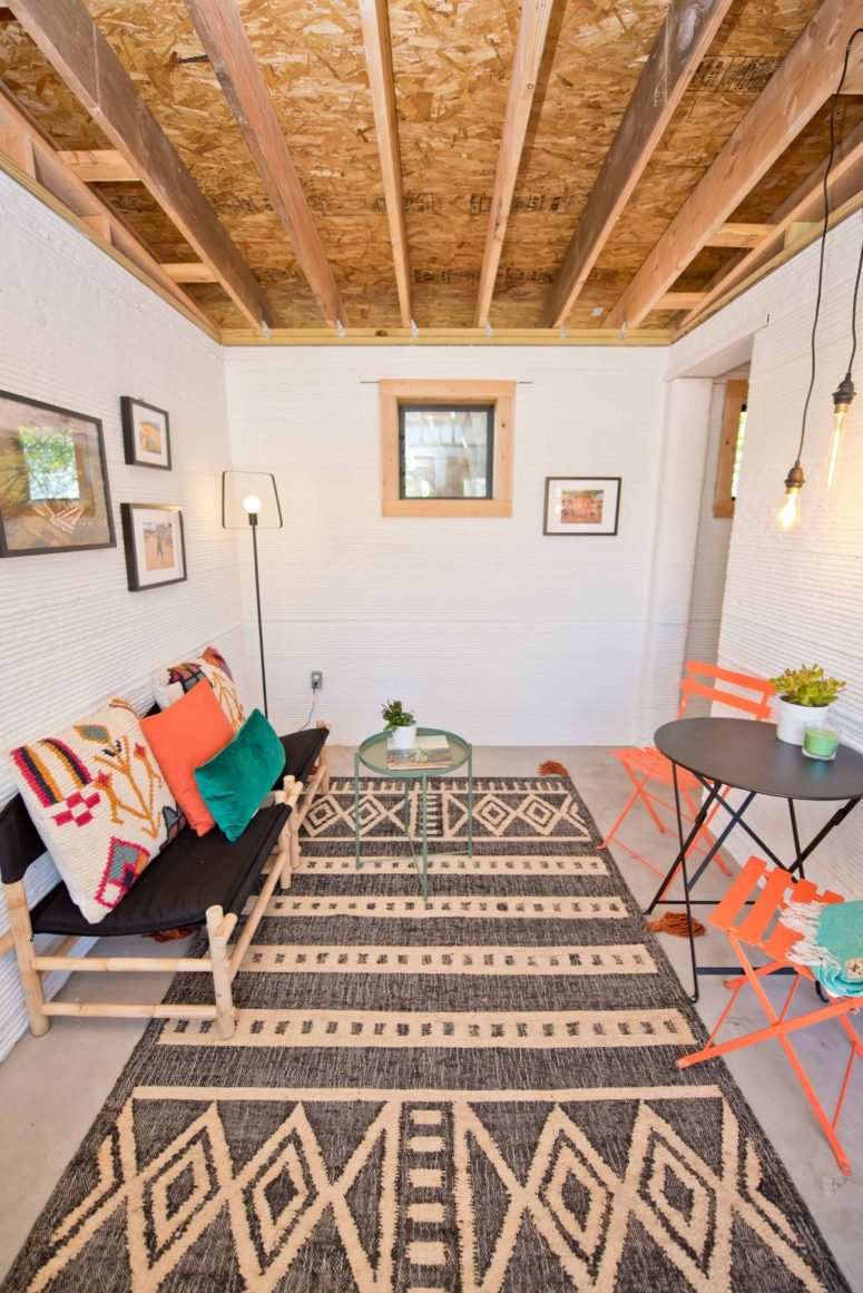 The lounge features rattan and wooden furniture, a gallery wall and an uncovered ceiling for an industrial feel The lounge features rattan and wooden furniture, a gallery wall and an uncovered ceiling for an industrial feel