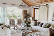living room with a stylish wooden ceiling and a statement chandelier