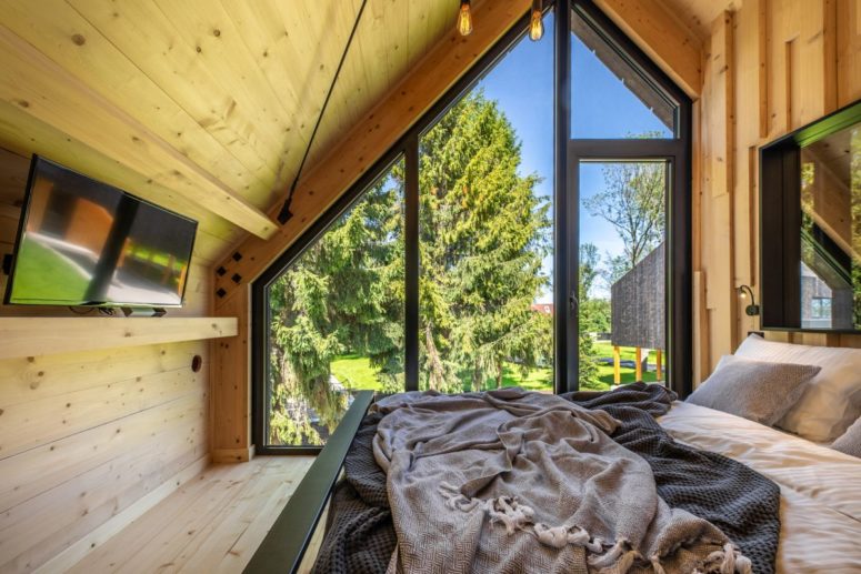Although small, the bedroom doesn’t look or feel tiny thanks large windows