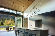 08 The kitchen is super sleek, with neutral wooden cabinets and a large kitchen island