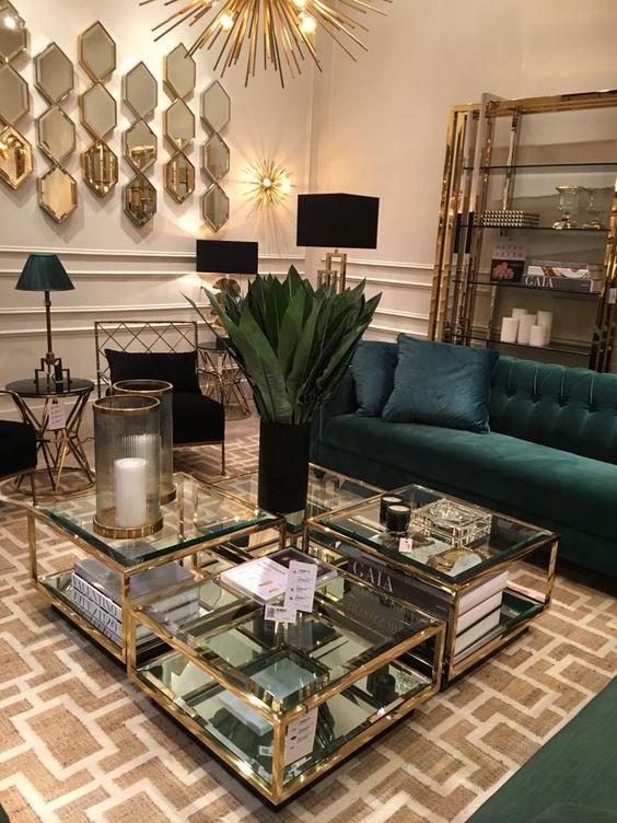 an elegant art deco living room with a sunburst chandelier, matching wall lamps and mirrors to reflect this light