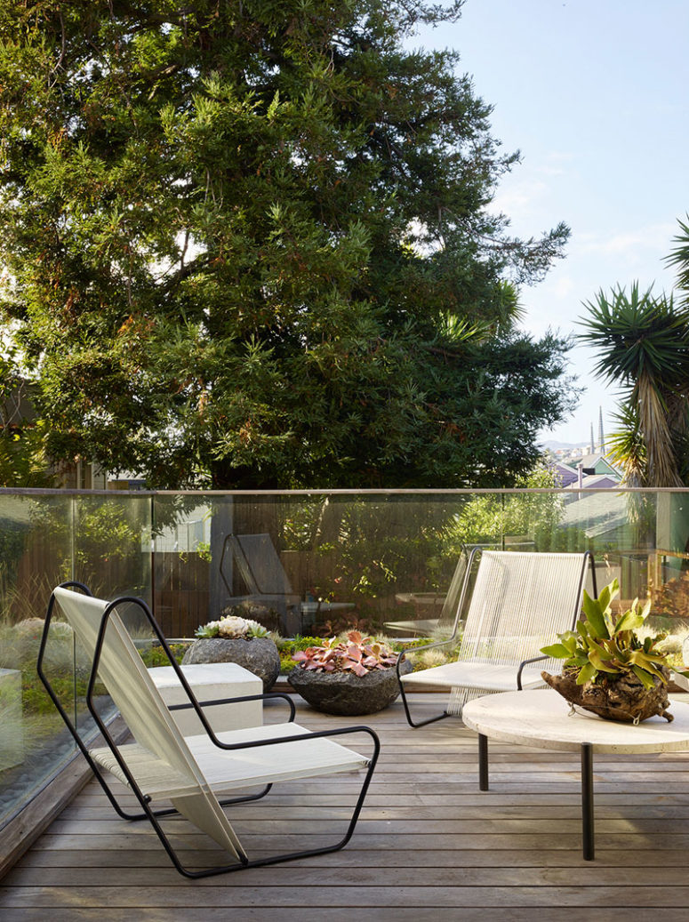 The terrace is laconic and simple and features amazing modern chairs