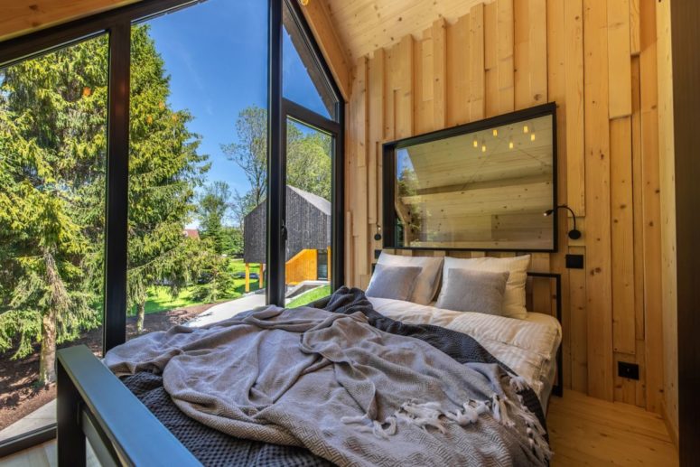 The walls, floor and ceiling of the bedroom are covered in wood and that creates a very cozy and inviting ambiance The walls, floor and ceiling of the bedroom are covered in wood and that creates a very cozy and inviting ambiance