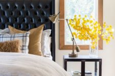09 a black leather wingback tufted headboard and a dark stained nightstand add drama to the neutral bedroom