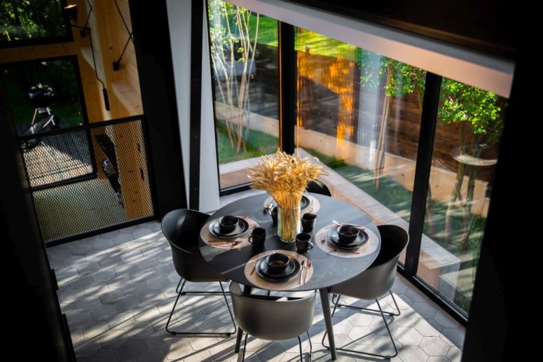 a small dining zone by the window The dining area is small and placed in the corner from where it overlooks the courtyard area