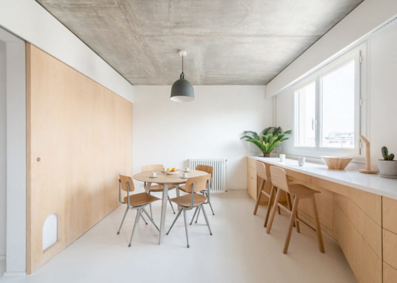 The home office features lower cabinets that are sleek and have no handles, and the windowsill acts as a desk or countertop