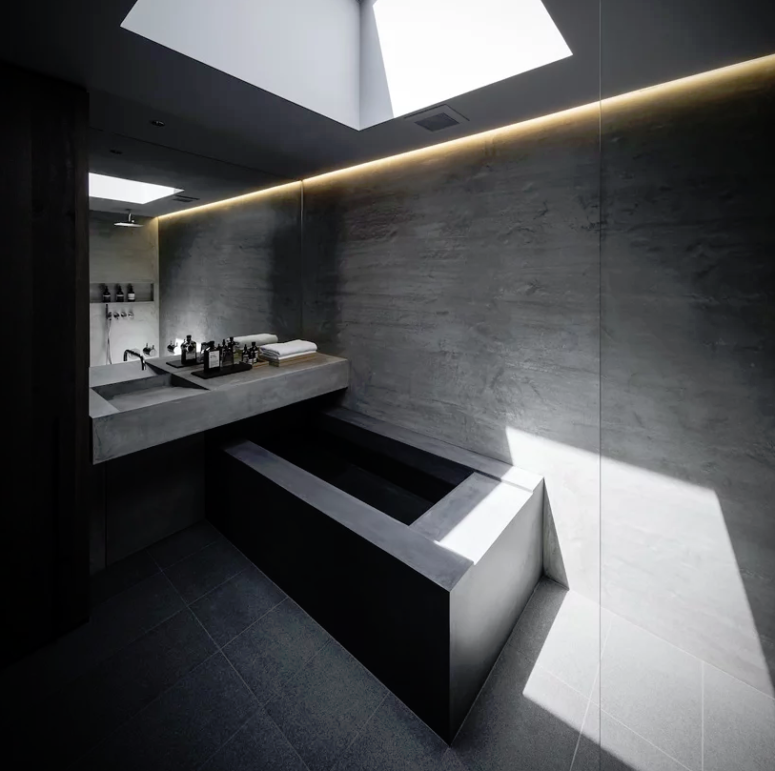 The bathroom is ultra-minimalist, with a skylight and a bathtub of concrete plus LED lights