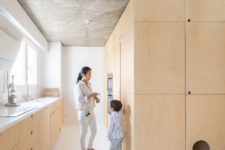 11 The kitchen is done with sleek plywood cabinets, a neutral countertop and some built-ins
