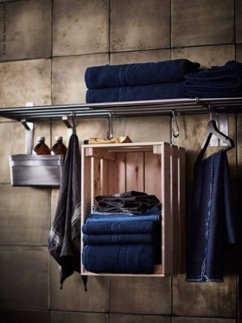 an IKEA Knagglig box hung on hooks and used as a towel holder is a creative idea to add a bit of storage space