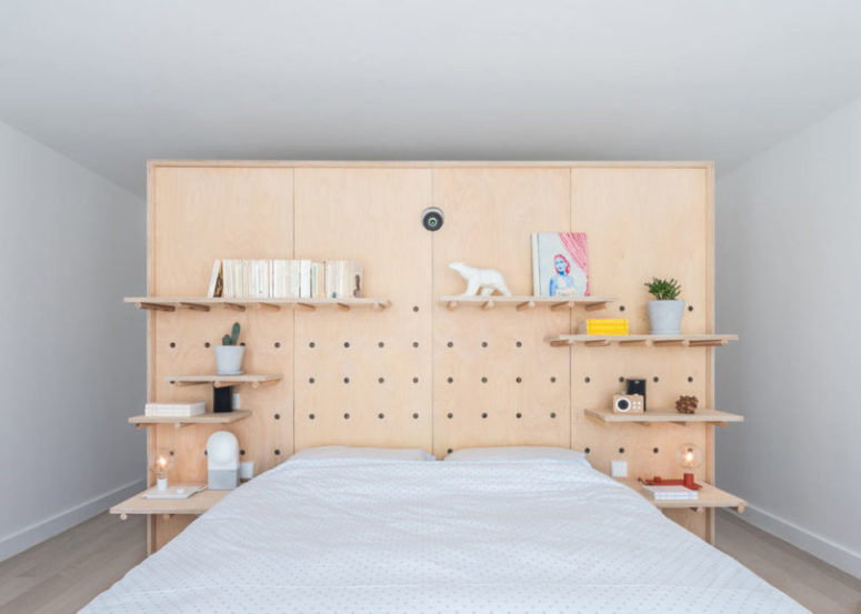 The master bedroom is done with a pegboard headboard for functionality and lots of shelves plus a bed The master bedroom is done with a pegboard headboard for functionality and lots of shelves plus a bed