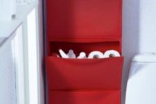 14 a bright red IKEA Trones piece attached to the wall and used for storing bathroom supplies