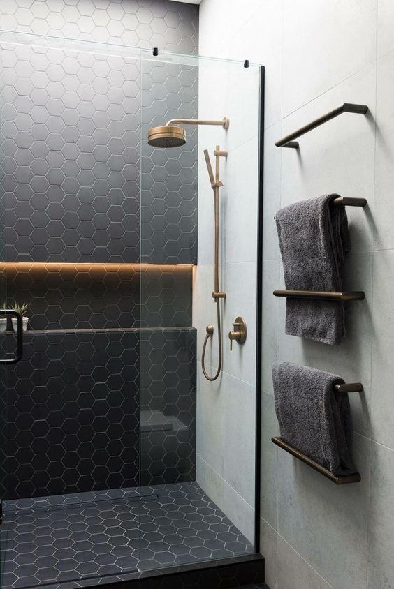 matte black hex tiles accented with neutrla grout and paired with large scale neutral tiles