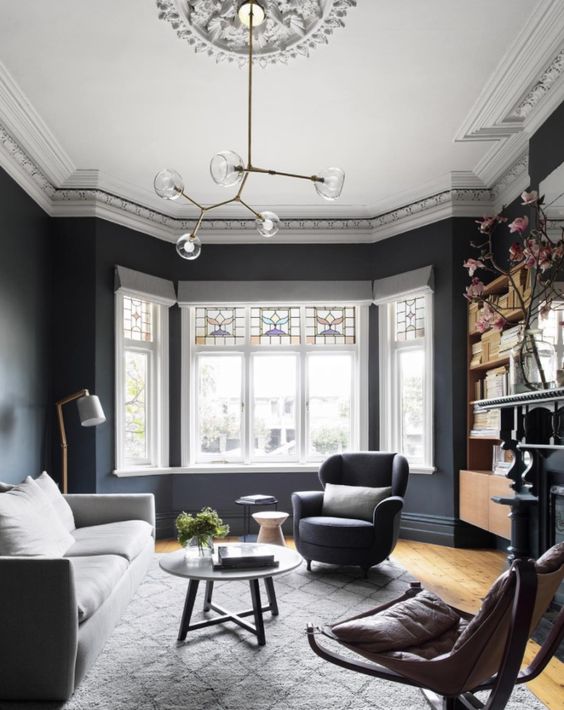 a catchy mid-century modern chandelier accented with a ceiling medallion is a cool idea