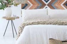 16 a painted wooden headboard with a chevron pattern, a wicker lampshade and a jute rug for a boho meets rustic feel