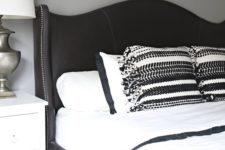 17 a black curved wingback headboard with decorative nail trim is a chic vintage-inspired idea