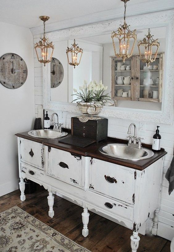 a shabby chic vanity space with adorable vintage pendant lamps over the vanity that add a refined touch