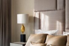 19 a beige padded upholstered headboard with a geometric pattern comes up to the ceiling and makes an elegant statement