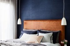 20 a brown leather upholstered headboard is a warming up touch to the welcoming bedroom done in grey and navy