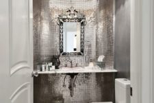 20 a glam mudroom with shiny reflective tiles, a marble floor and a refined frame mirror