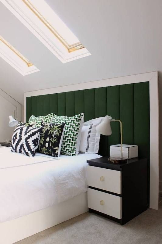 a gorgeous dark green upholstered headboard with a wide white frame for a contrasting and bold combo