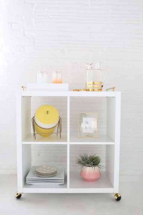 a simple contemporary home bar of an IKEA Kallax unit with casters - it features enough storage