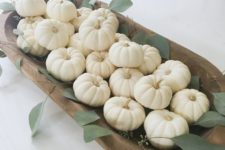23 a pretty fall centerpiece of a wooden dough bowl filled wiht white pumpkins and greenery