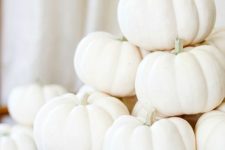 24 a glam fall arrangement of a vintage metal holder and a stack of white pumpkins