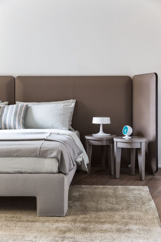 an extended sleek brown leather headboard of several parts is a very chic contemporary idea