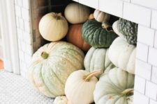 28 a non-working fireplace fully filled with heirloom pumpkins is an amazing fall idea