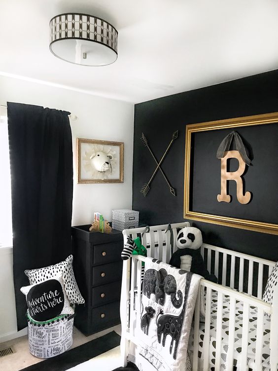 a black and white room with an accent wall, a black dresser and curtains and a striped rug is a cool and bold space